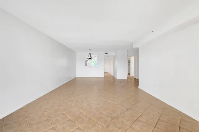 a kitchen with granite countertop a refrigerator and a stove top oven