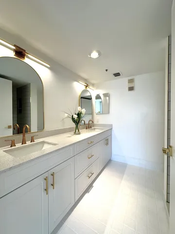 a bathroom with a sink a toilet and a mirror