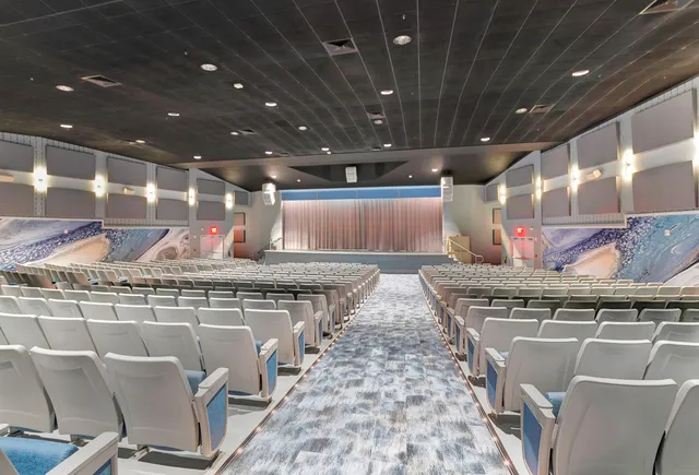 a living room with furniture a table and chairs