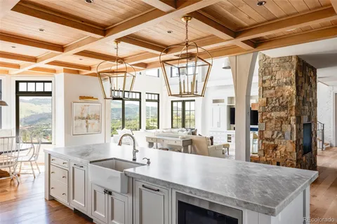 a view of a kitchen with a sink and wooden floor