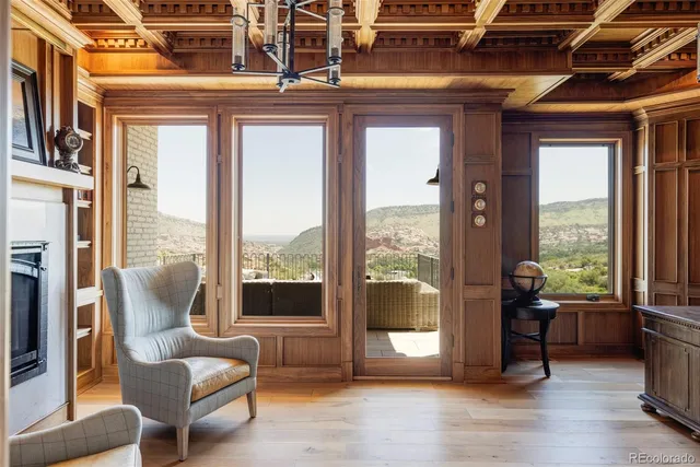 a living room with furniture and a floor to ceiling window