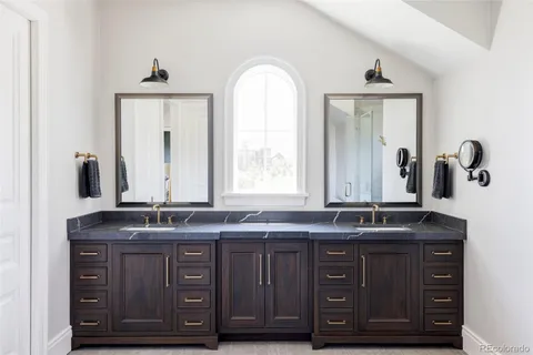 a bathroom with a double vanity sink and mirror