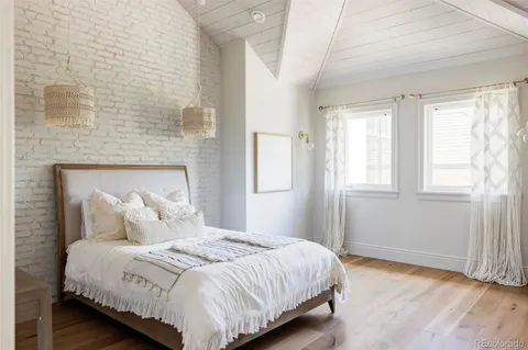 a bedroom with a bed and a fireplace