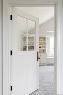 a view of empty room with wooden floor and white walls