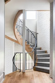 a view of staircase with lots of frames on wall