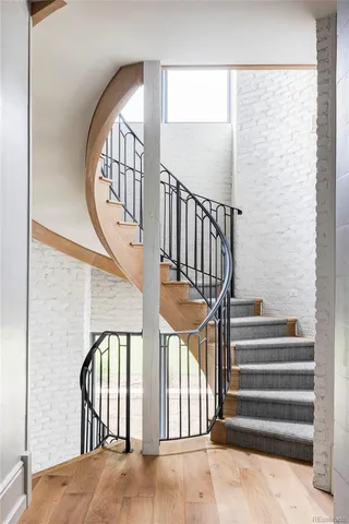 a view of staircase with lots of frames on wall