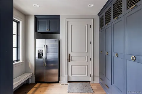 a metallic refrigerator freezer and a stove sitting inside of a kitchen