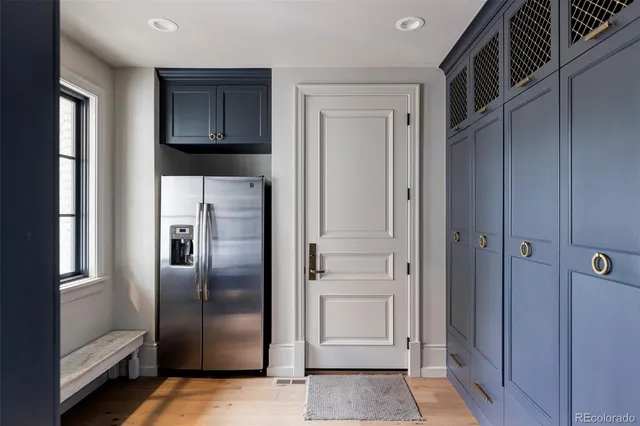 a metallic refrigerator freezer and a stove sitting inside of a kitchen
