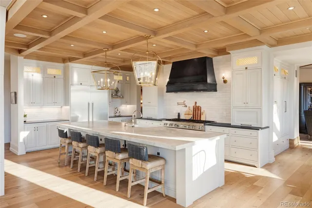 a kitchen with stainless steel appliances a stove a sink and a refrigerator