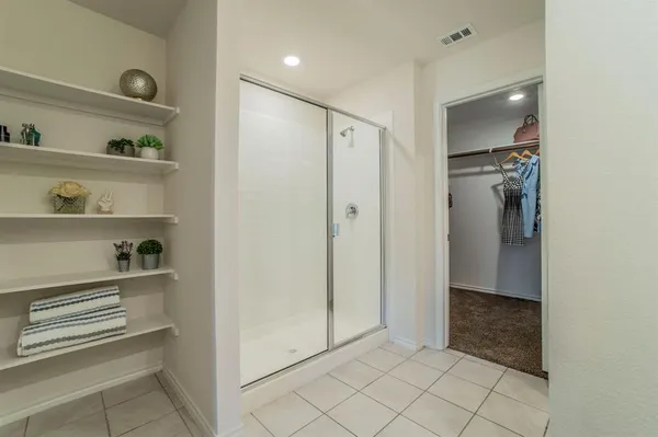 a bedroom with a bed and a potted plant