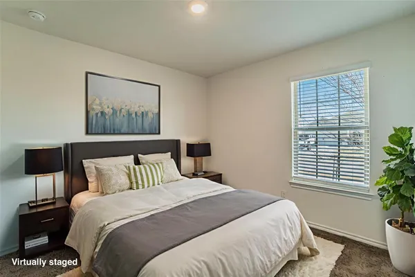 a bedroom with a bed and a potted plant