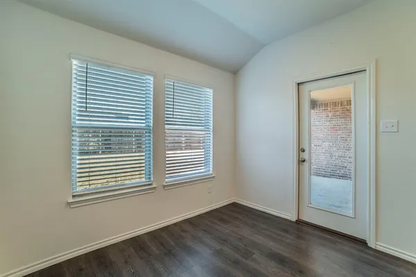 an empty room with a empty space and windows