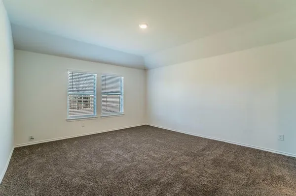 a bedroom with a large bed and a painting on the wall