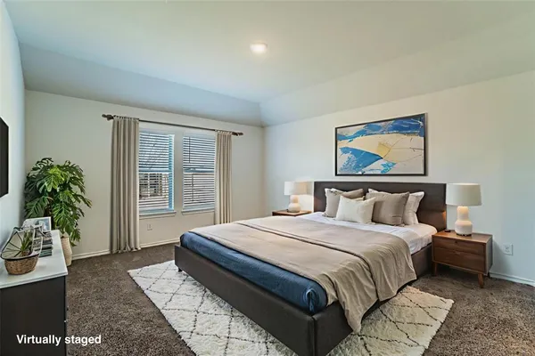 a bedroom with a large bed and a painting on the wall