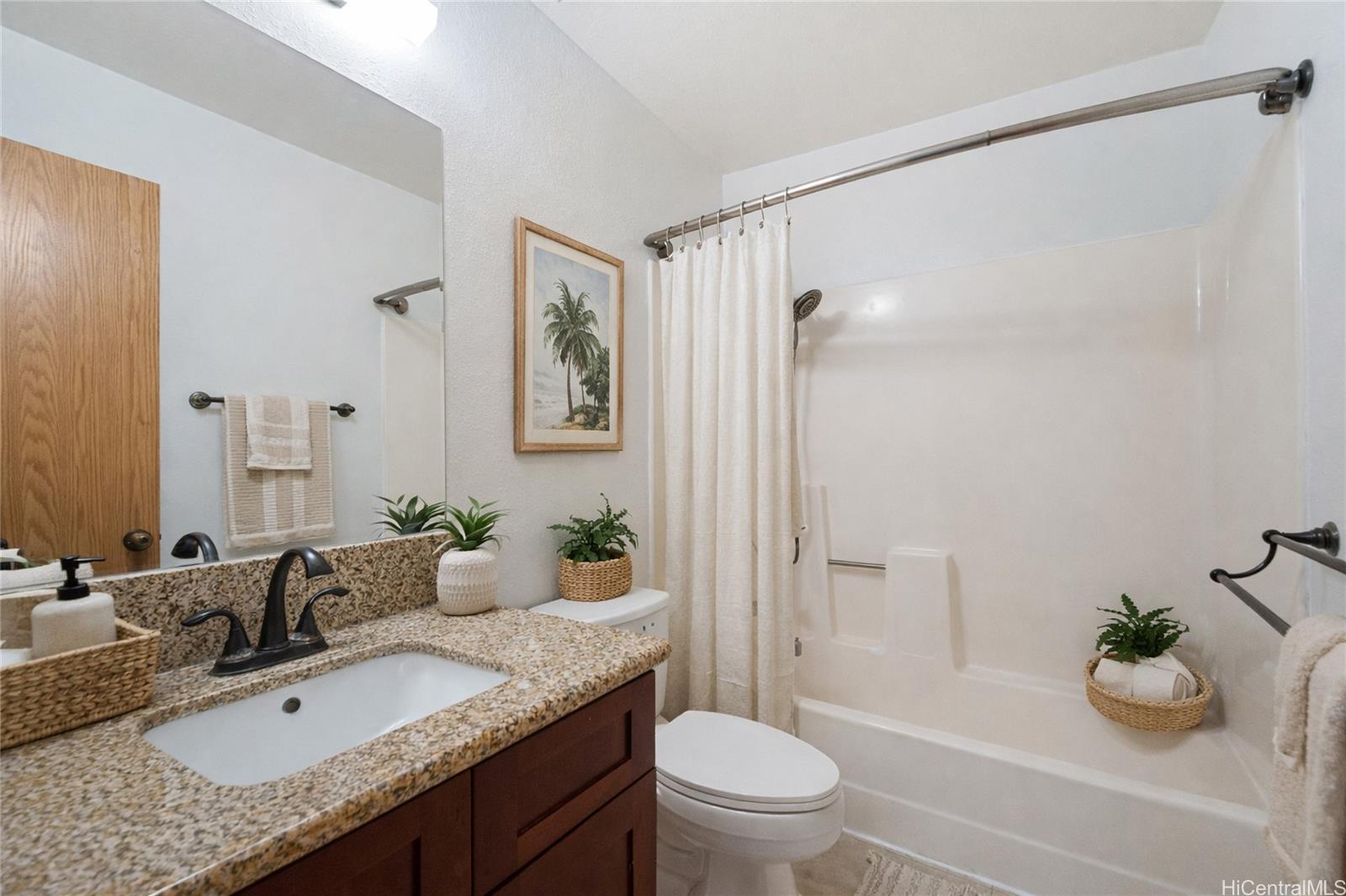 98-941 Moanalua Road, Unit 403 Aiea, HI 96701 - Photo 13 of 19 a bathroom with a granite countertop sink toilet and shower