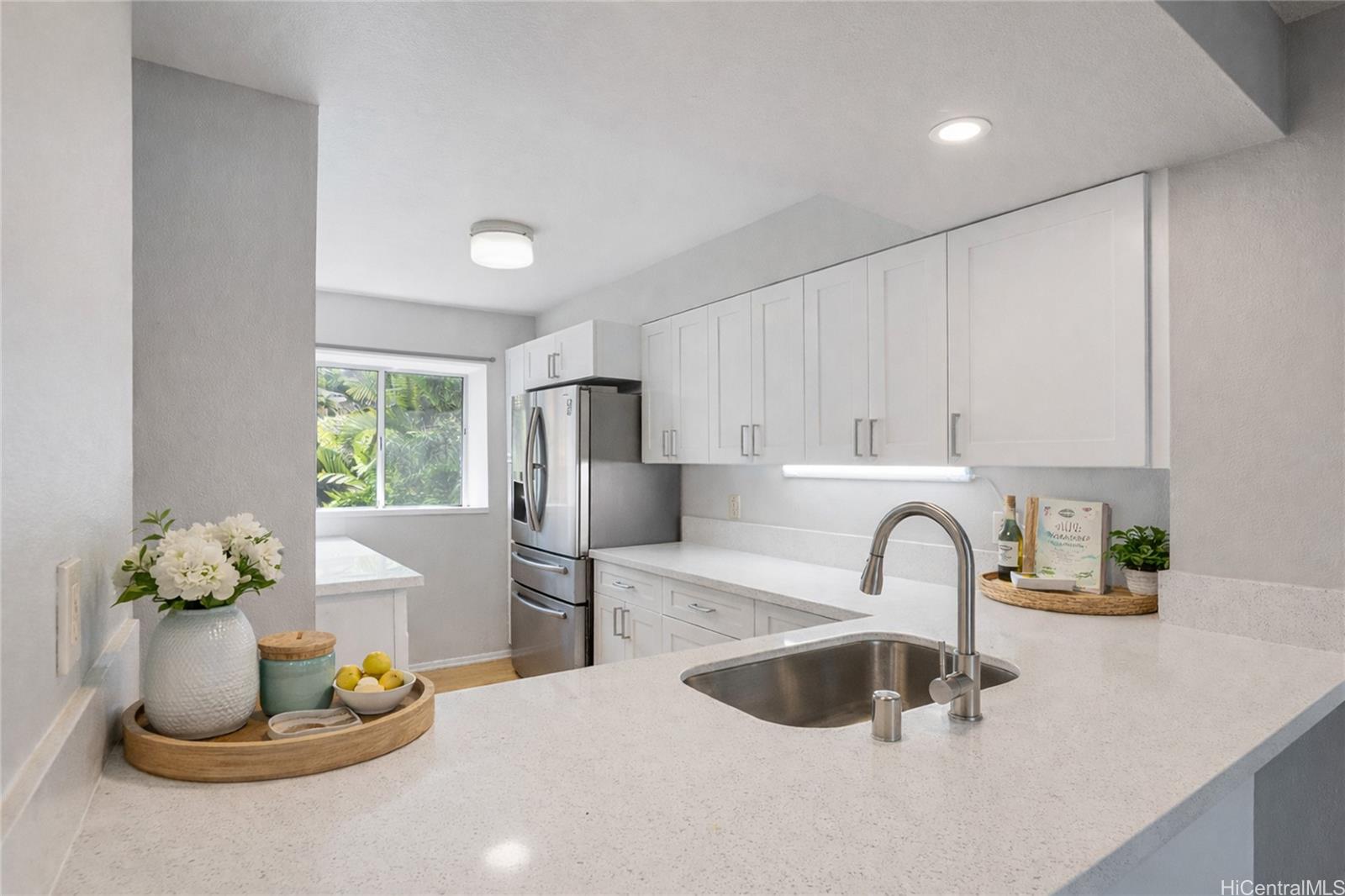 98-941 Moanalua Road, Unit 403 Aiea, HI 96701 - Photo 4 of 19 a kitchen with a sink appliances and a counter top space
