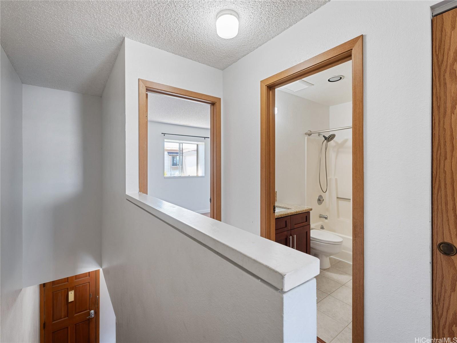 98-941 Moanalua Road, Unit 403 Aiea, HI 96701 - Photo 8 of 19 a bathroom with a sink a mirror and a window