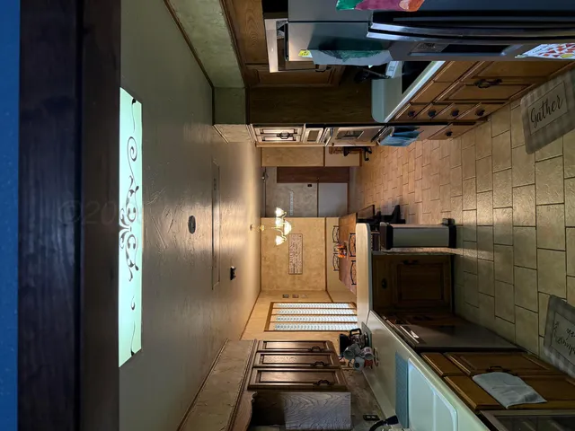 a kitchen with stainless steel appliances kitchen island a stove and a refrigerator