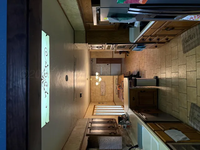 a kitchen with stainless steel appliances kitchen island a stove and a refrigerator