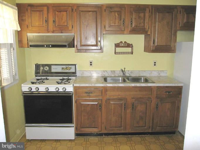 6431 Blenheim Road Baltimore, MD 21212 - Photo 7 of 12 a kitchen with stainless steel appliances granite countertop a stove a sink and a microwave