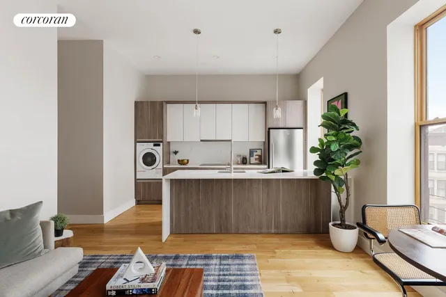 a view of kitchen with sink refrigerator and dining table