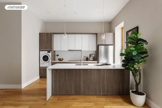 a kitchen with stainless steel appliances granite countertop a sink a stove and a wooden floors