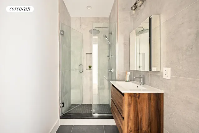 a bathroom with a sink a mirror and a shower