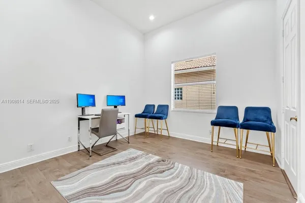 a workspace with furniture and a wooden floor