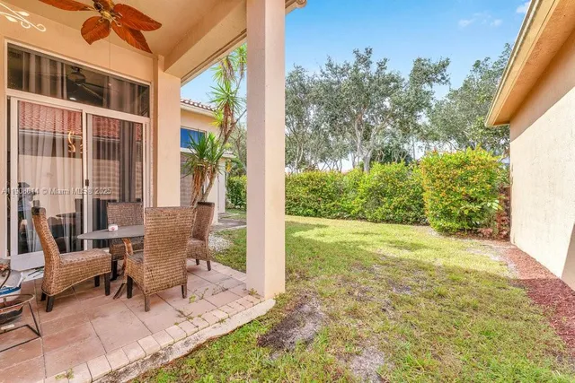 a view of a patio with table and chairs and potted plants