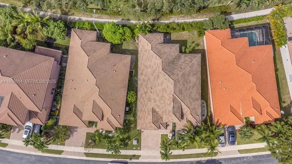 an aerial view of a house with a yard and plants