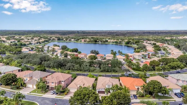 an aerial view of house with yard and ocean view