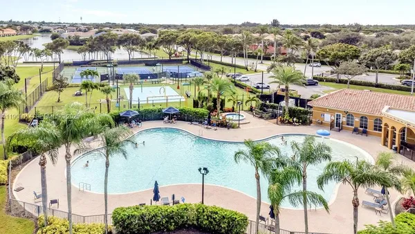 an aerial view of residential houses with outdoor space and river