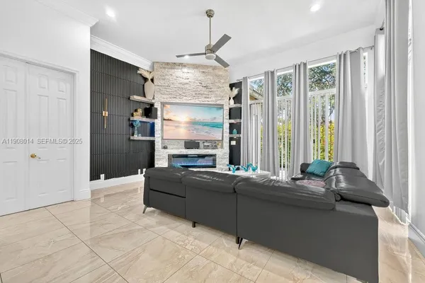 a living room with furniture and large windows