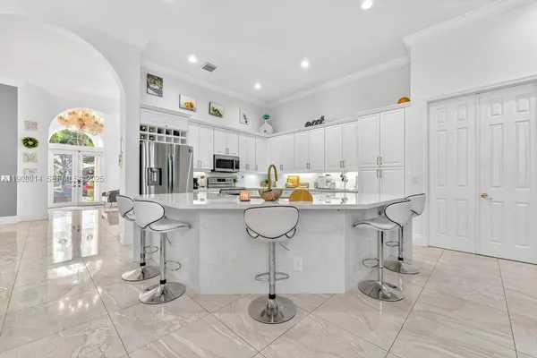 a kitchen with white cabinets and appliances