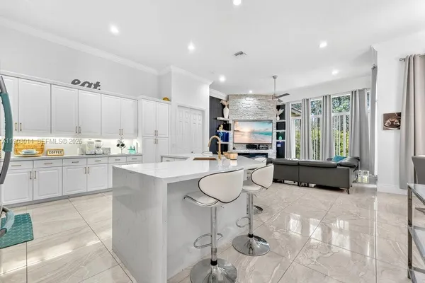 a kitchen with stainless steel appliances granite countertop a refrigerator sink and cabinets