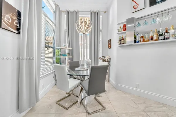 a dining room with furniture and window