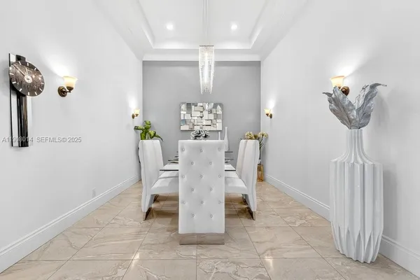 a dining room with furniture and a chandelier
