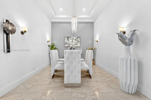 a dining room with furniture and a chandelier