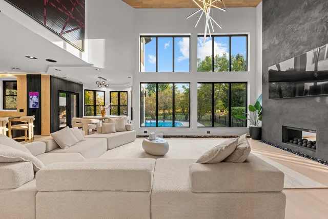 a spacious bedroom with a bed and a chandelier
