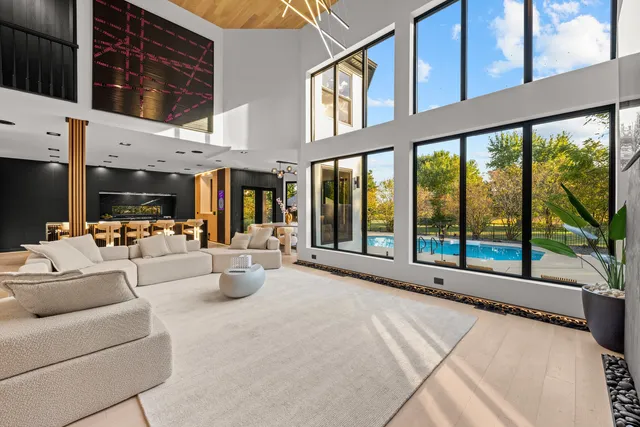 a spacious bedroom with a large bed and a chandelier