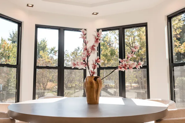 a view of a workspace with furniture and a window