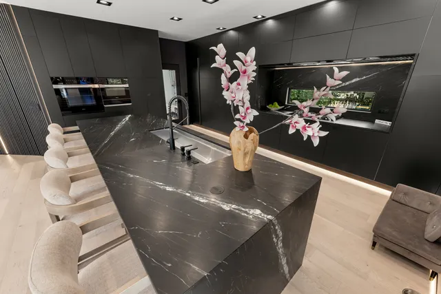 a bedroom with a bed a dresser and next to a window