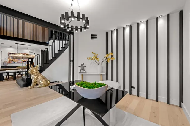 a living room with furniture a flat screen tv and a floor to ceiling window