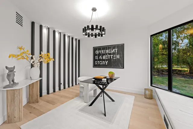 a living room with furniture a large window and a fireplace