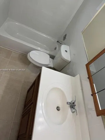a bathroom with a toilet and a tub