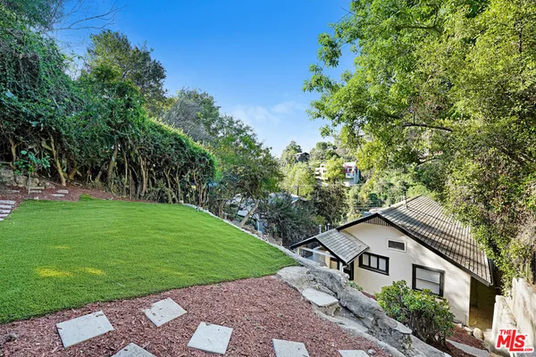a view of house with a yard