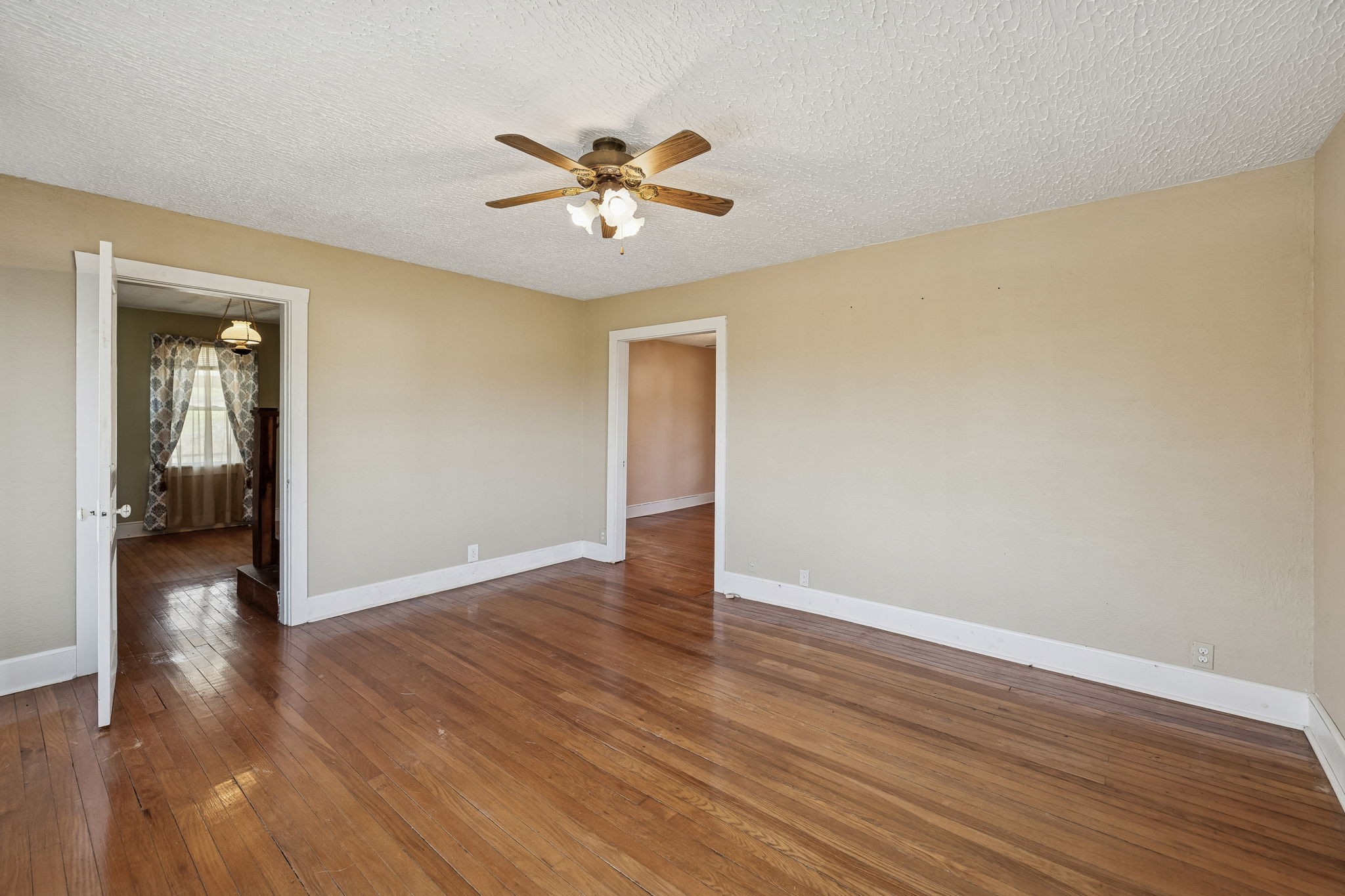 2554 Bakerton Road Red Boiling Springs, TN 37150 - Photo 11 of 46 a view of a livingroom with wooden floor and a ceiling fan