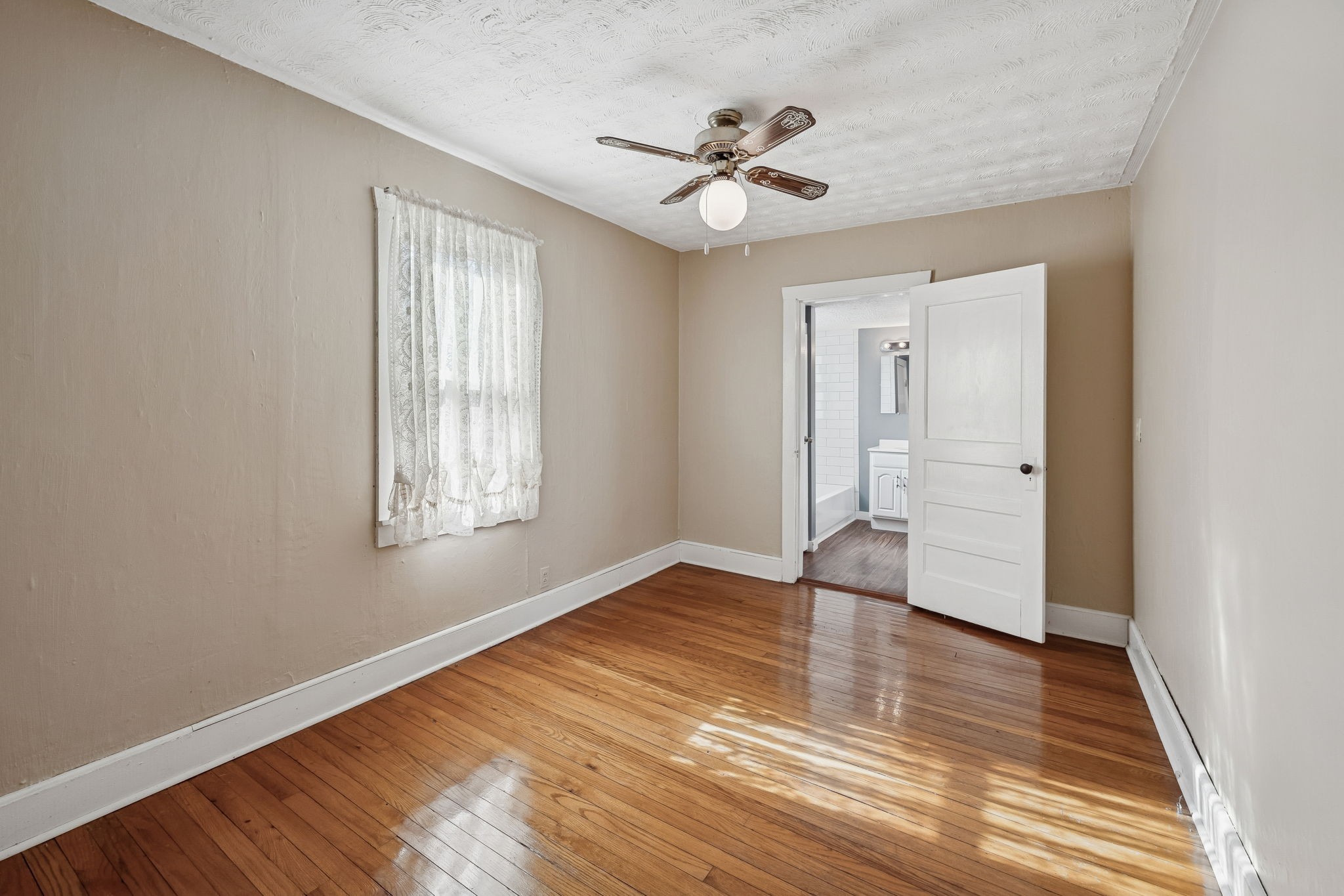 2554 Bakerton Road Red Boiling Springs, TN 37150 - Photo 15 of 46 a view of an empty room with wooden floor and a window