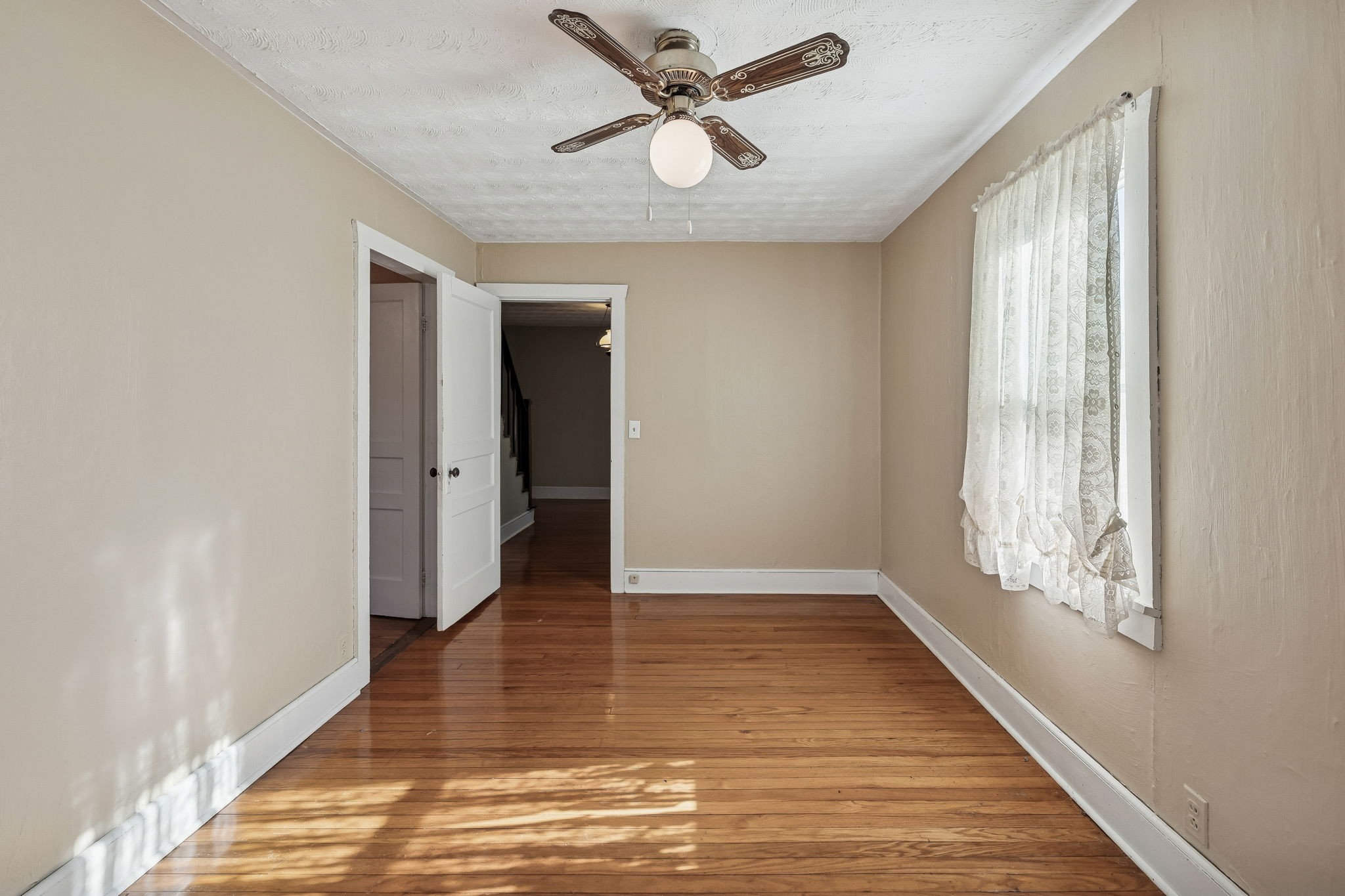 2554 Bakerton Road Red Boiling Springs, TN 37150 - Photo 17 of 46 a view of an empty room with window and wooden floor