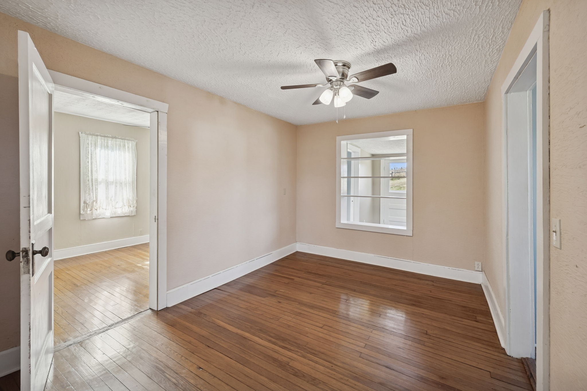 2554 Bakerton Road Red Boiling Springs, TN 37150 - Photo 19 of 46 a view of an empty room with a window and wooden floor